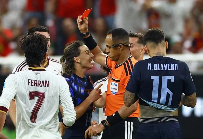 Uruguay's Agustin Canobbio is shown the red card by referee Ismail Elfath.