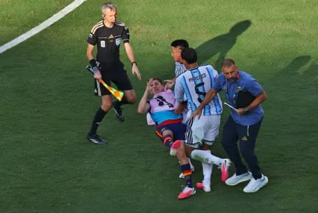 Gavi is attacked by Thiago Almada and Leandro Paredes of Argentina after the World Cup final