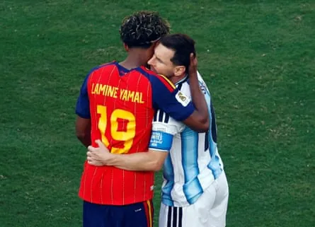 Spain’s Lamine Yamal and Argentina’s Lionel Messi embrace after the match